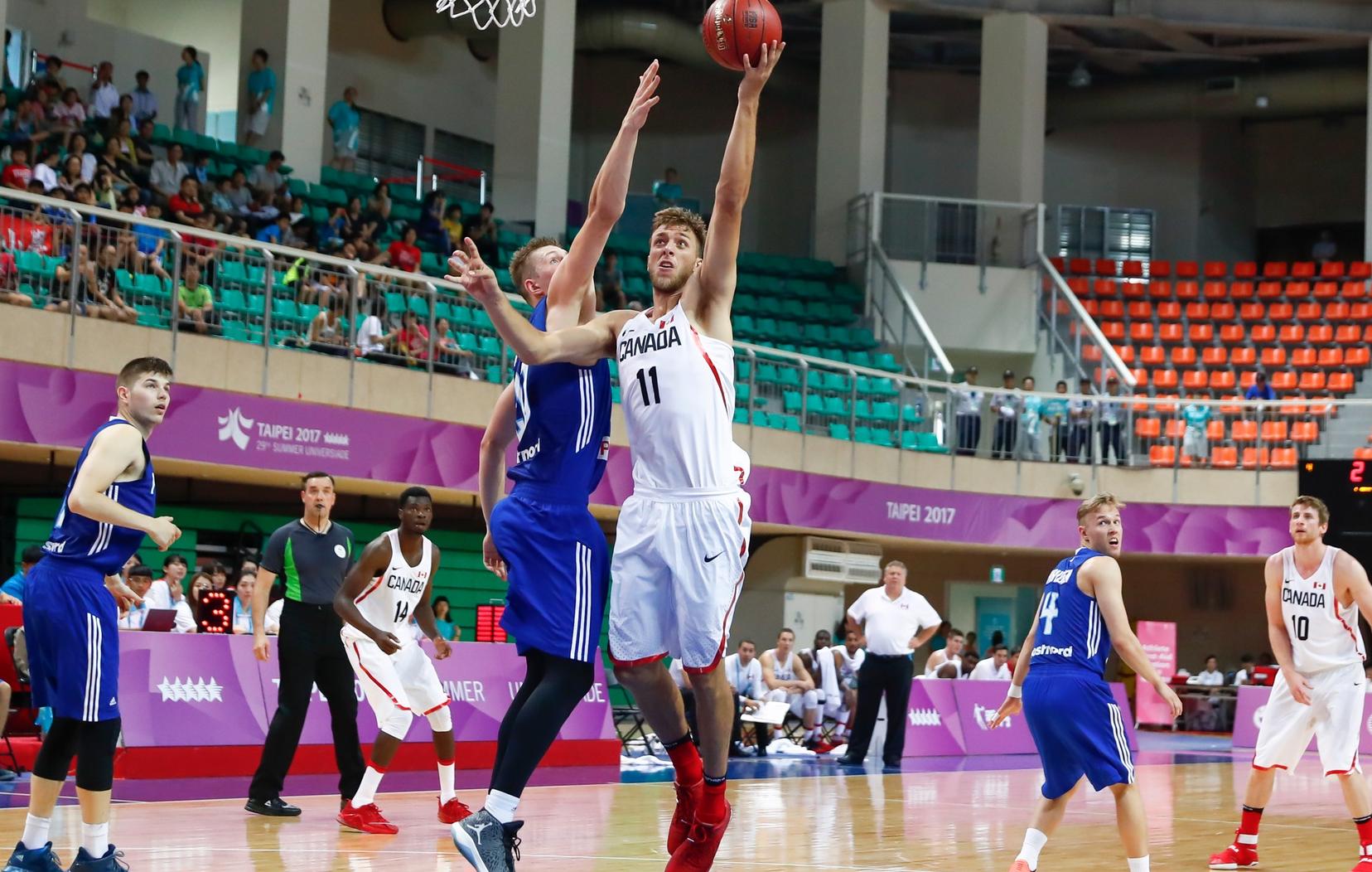Mathieu Belanger / Erik Nissen goes up for a layup for Canada in men's basketball action against Finland on Monday, August 21. The Canadians lost 79-71 to the Finns.
